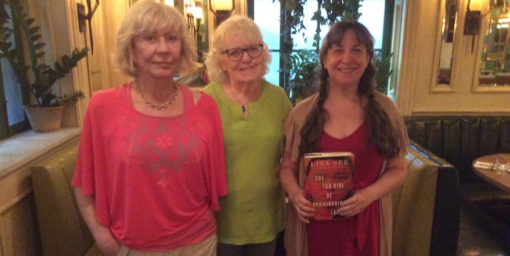 Alice Weolwska, Eileen Donovan, and Jill Wisoff holding a copy of The Tea Girl of Hummingbird Lane